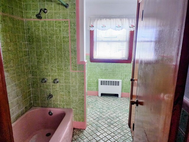 55 Kilburn St, Revere, MA 02151 - bathroom featuring tile walls, radiator, tile patterned flooring, and tub / shower combination