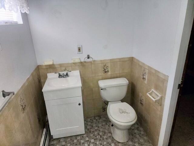 55 Kilburn St, Revere, MA 02151 - bathroom featuring toilet, a wainscoted wall, tile walls, and vanity