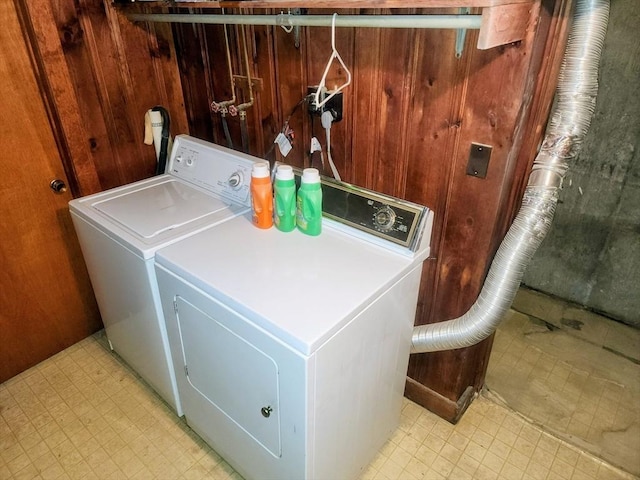 55 Kilburn St, Revere, MA 02151 - laundry area featuring light floors, independent washer and dryer, wood walls, and laundry area