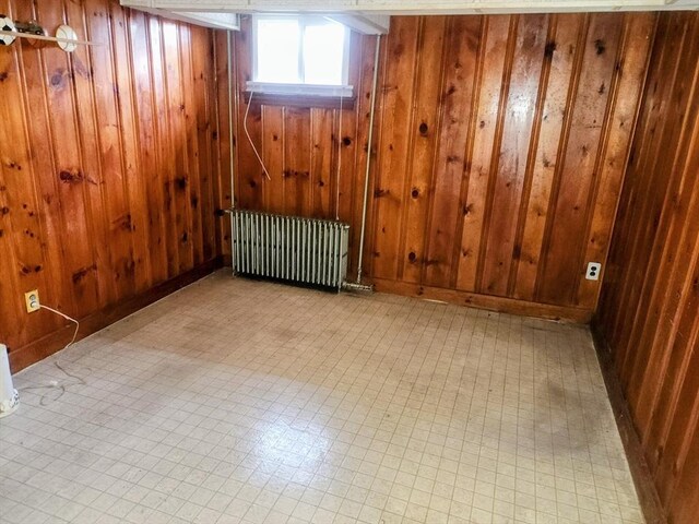 55 Kilburn St, Revere, MA 02151 - below grade area with radiator heating unit and wood walls