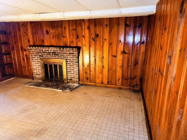 55 Kilburn St, Revere, MA 02151 - unfurnished living room with wood walls, tile patterned floors, and a fireplace