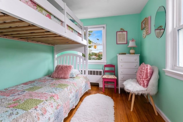 2 Olympia Ave, Woburn, MA 01801 - bedroom featuring radiator, wood finished floors, and baseboards