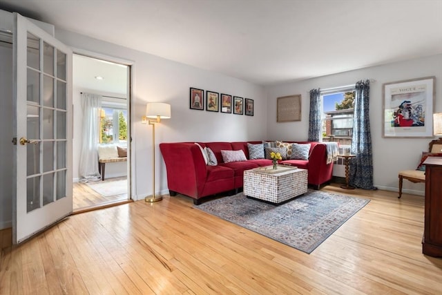 2 Olympia Ave, Woburn, MA 01801 - living room with plenty of natural light, hardwood / wood-style floors, and baseboards