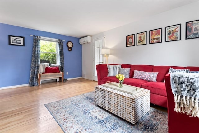 2 Olympia Ave, Woburn, MA 01801 - living area featuring a wall unit AC, wood finished floors, and baseboards