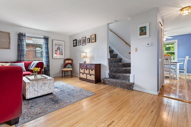 2 Olympia Ave, Woburn, MA 01801 - living room with wood-type flooring, stairway, a ceiling fan, and baseboards