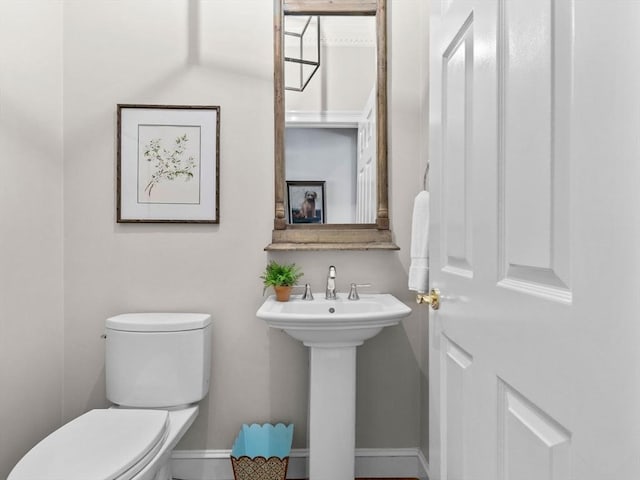 21A Farm St, Dover, MA 02030 - half bathroom featuring toilet, baseboards, and a sink