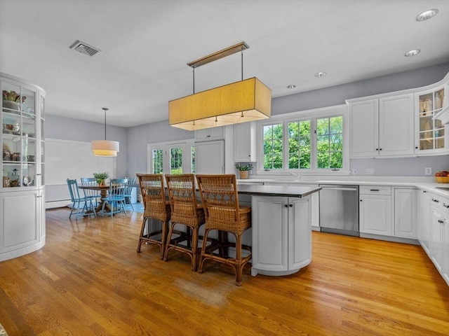 21A Farm St, Dover, MA 02030 - kitchen with dishwasher, a center island, light wood-style flooring, white cabinetry, and recessed lighting