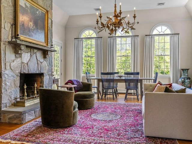 21A Farm St, Dover, MA 02030 - living area with wood finished floors, vaulted ceiling, plenty of natural light, a chandelier, and a stone fireplace