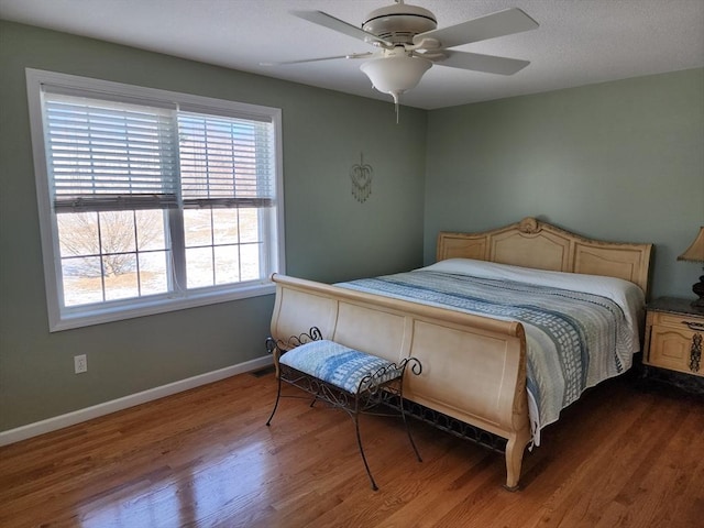 bedroom featuring hardwood / wood-style flooring and ceiling fan