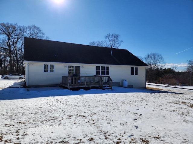 snow covered property featuring a deck