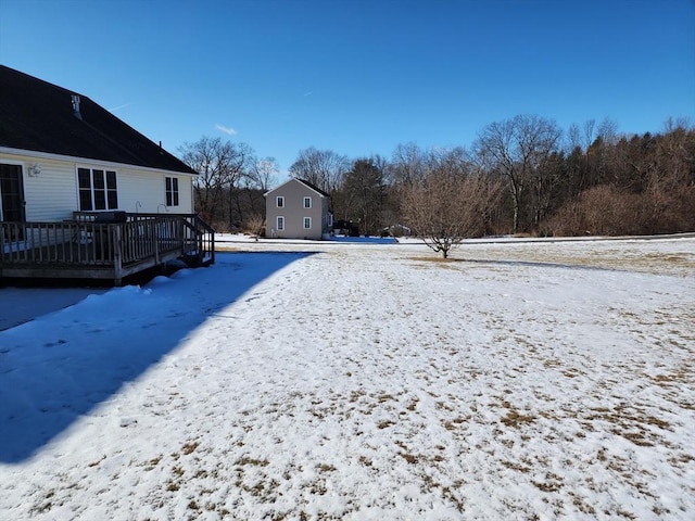 snowy yard featuring a deck