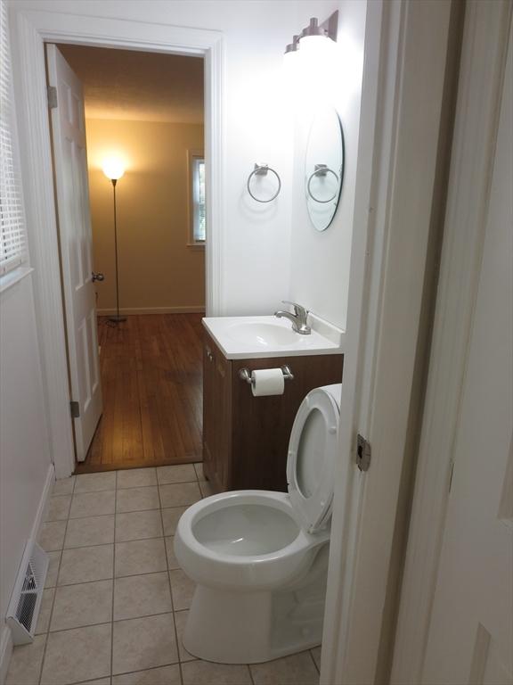 130 Fuller Rd, Barnstable, MA 02632 - half bath with vanity, tile patterned flooring, toilet, and baseboards