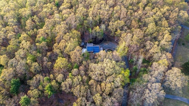 birds eye view of property featuring a wooded view