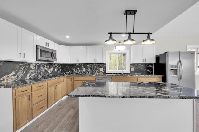 kitchen with white cabinetry, light wood-type flooring, stainless steel appliances, and a sink