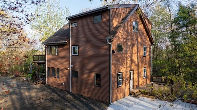 view of home's exterior with a wooden deck