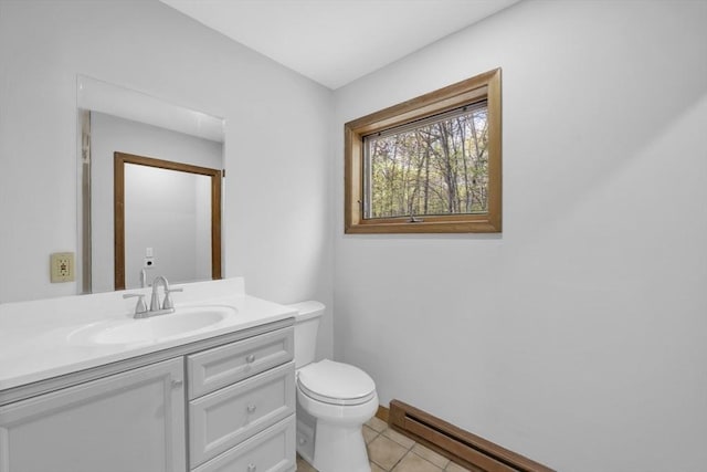 bathroom featuring vanity, toilet, tile patterned flooring, and a baseboard heating unit