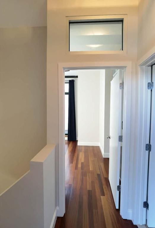 hallway with dark wood-type flooring