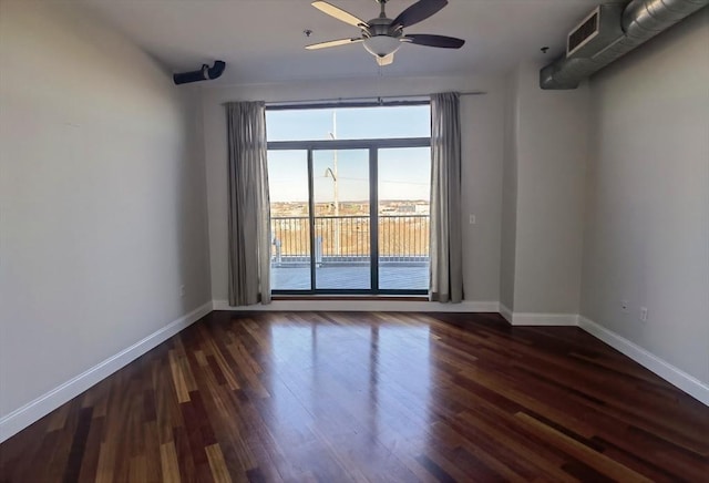 spare room with dark hardwood / wood-style floors and ceiling fan