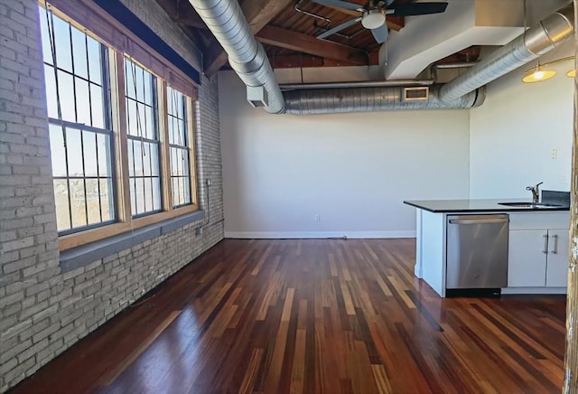 interior space with sink, white cabinetry, dark hardwood / wood-style flooring, dishwasher, and brick wall