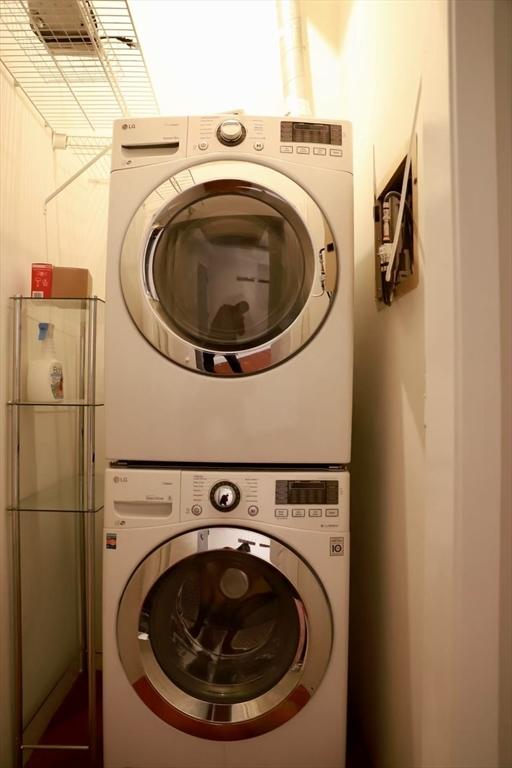 laundry area featuring stacked washer and clothes dryer