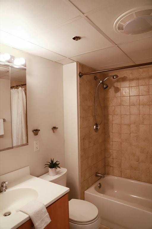 full bathroom with tiled shower / bath combo, vanity, and toilet