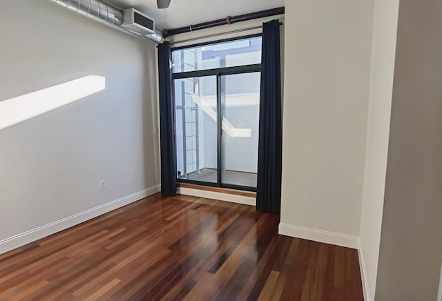 unfurnished room with dark hardwood / wood-style floors