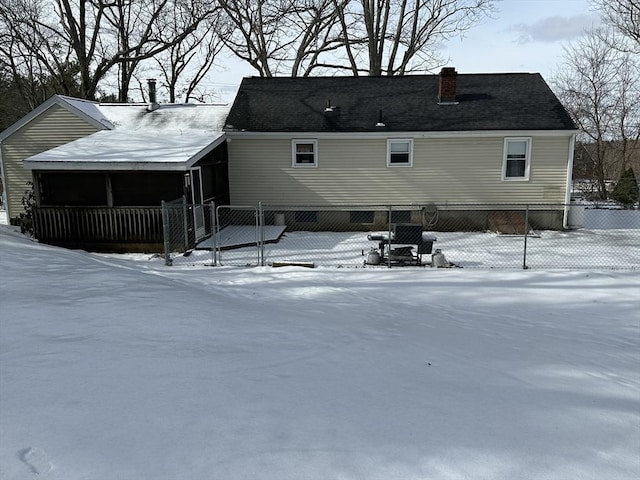 view of snow covered back of property