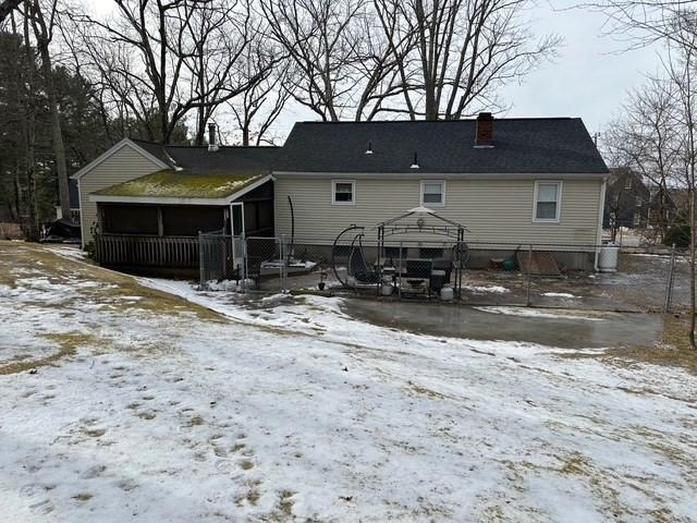 snow covered rear of property featuring a gazebo