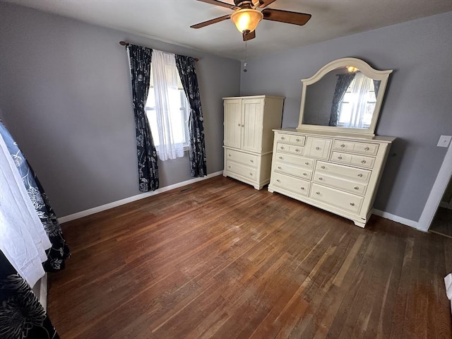 unfurnished bedroom featuring ceiling fan and dark hardwood / wood-style flooring