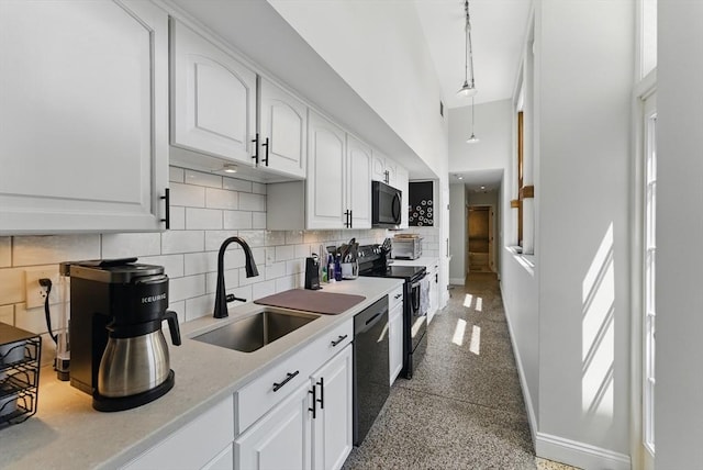 235 State St Unit 406, Springfield, MA 01103 - kitchen featuring black appliances, a sink, baseboards, white cabinetry, and tasteful backsplash