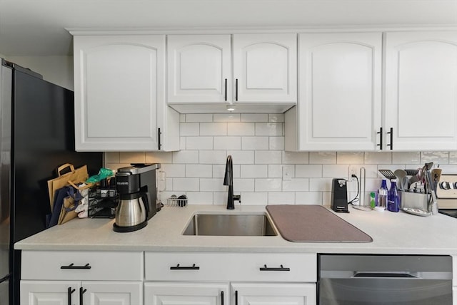 235 State St Unit 406, Springfield, MA 01103 - kitchen featuring stainless steel appliances, a sink, backsplash, light countertops, and white cabinetry