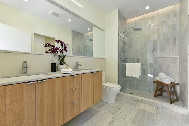 full bath featuring visible vents, a sink, toilet, and tiled shower