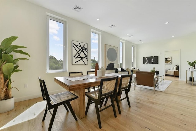 dining area with baseboards, light wood-type flooring, visible vents, and recessed lighting