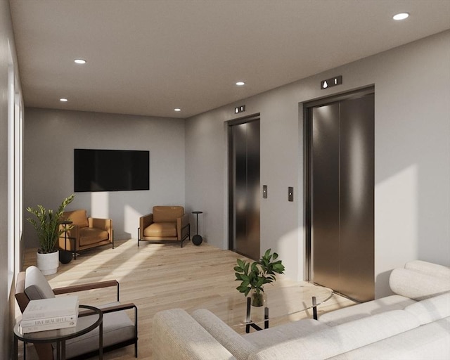 living area featuring recessed lighting, light wood-style flooring, and elevator