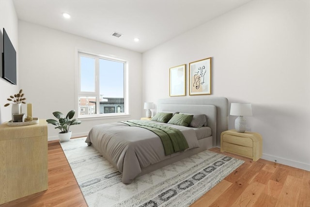 bedroom with recessed lighting, wood finished floors, visible vents, and baseboards