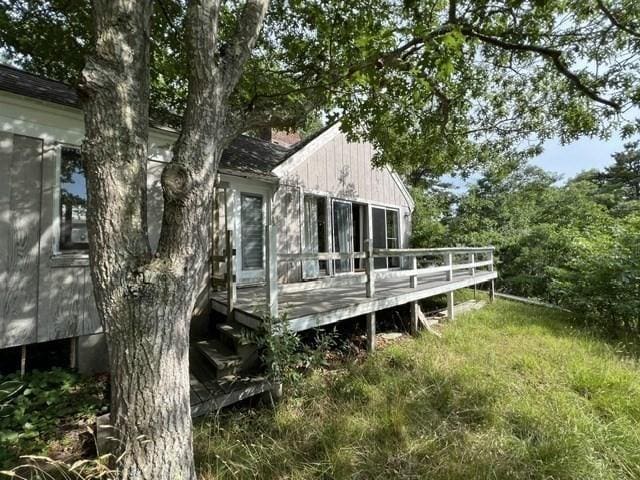 back of property featuring a wooden deck