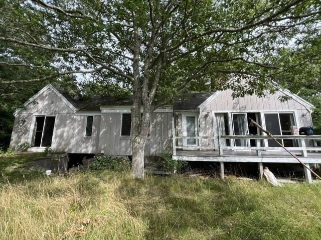 back of property with a wooden deck