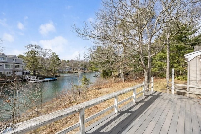 wooden terrace featuring a floating dock and a water view