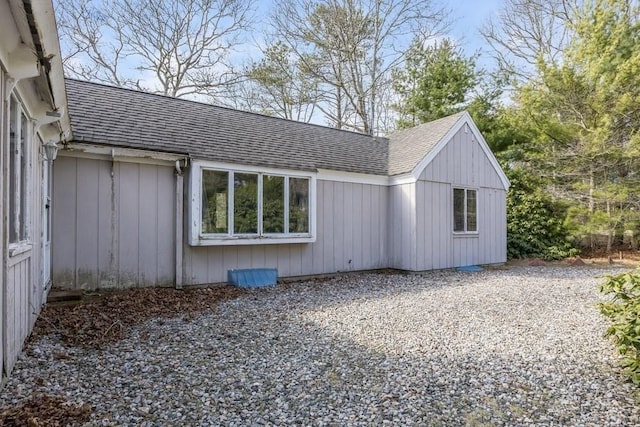 view of side of home featuring a shingled roof
