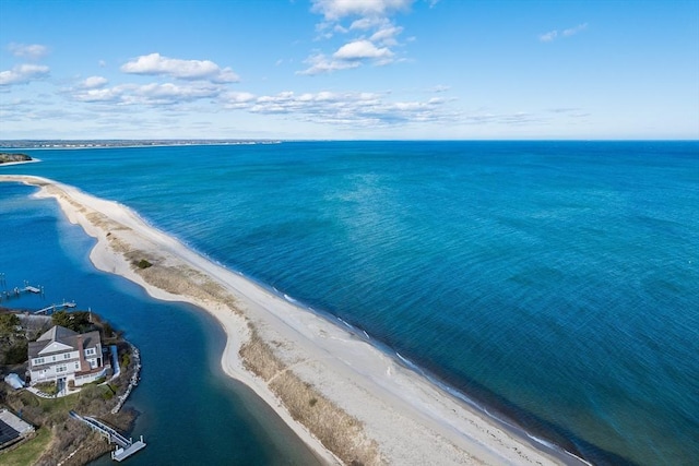 birds eye view of property featuring a beach view and a water view