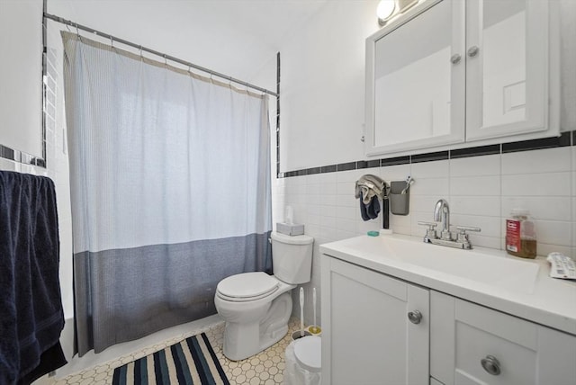 79 Poplar St Unit 10, Boston, MA 02131 - bathroom with toilet, vanity, tile walls, and a wainscoted wall