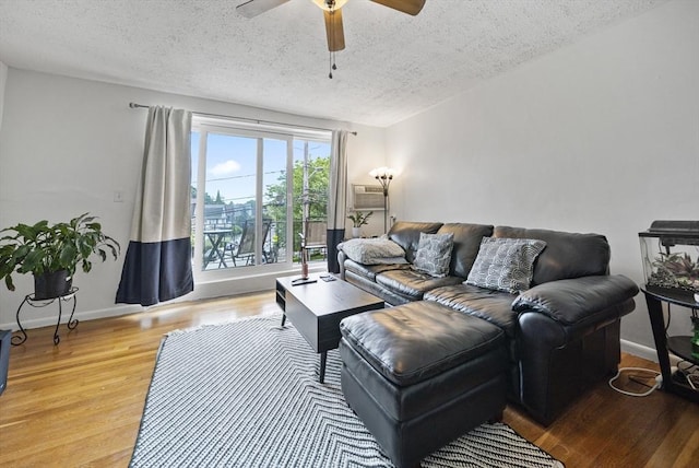 79 Poplar St Unit 10, Boston, MA 02131 - living room featuring a textured ceiling, ceiling fan, wood finished floors, and baseboards