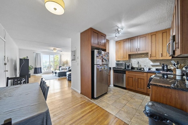 79 Poplar St Unit 10, Boston, MA 02131 - kitchen with appliances with stainless steel finishes, open floor plan, decorative backsplash, a sink, and light wood-style floors