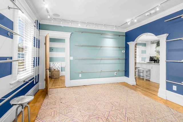 8 S St, Dennis, MA 02639 - empty room with ornate columns, track lighting, wood finished floors, arched walkways, and crown molding