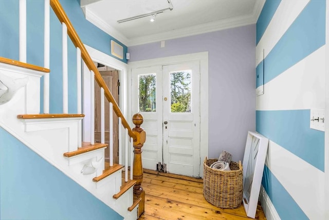 8 S St, Dennis, MA 02639 - entrance foyer featuring ornamental molding, rail lighting, wood-type flooring, and stairs