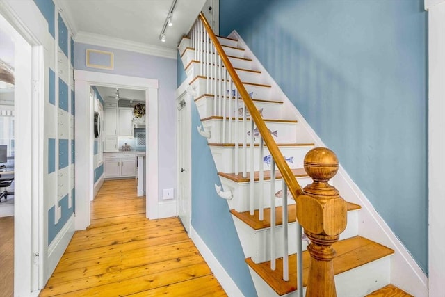 8 S St, Dennis, MA 02639 - staircase with hardwood / wood-style floors, ornamental molding, and rail lighting
