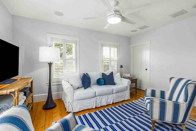 8 S St, Dennis, MA 02639 - living room with plenty of natural light, wood finished floors, baseboards, and a ceiling fan