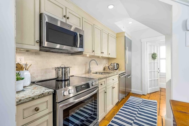 8 S St, Dennis, MA 02639 - kitchen featuring stainless steel appliances, a sink, decorative backsplash, baseboards, and recessed lighting