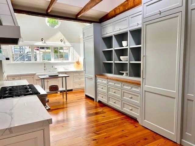 8 S St, Dennis, MA 02639 - kitchen featuring light wood-style floors, light stone countertops, beamed ceiling, open shelves, and stove