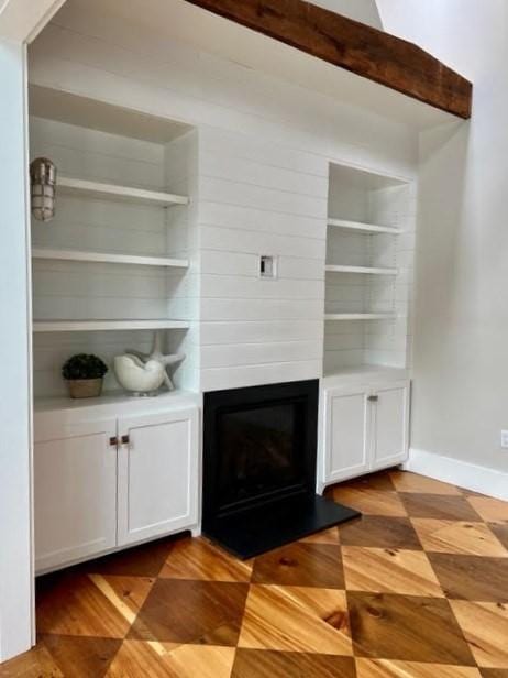 8 S St, Dennis, MA 02639 - unfurnished living room featuring a glass covered fireplace and baseboards